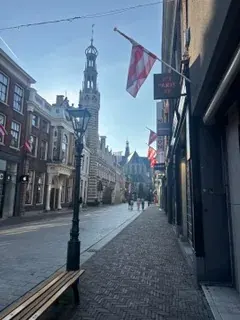 A lamp post on an Alkmaar shopping street with the Waagtoren beyond