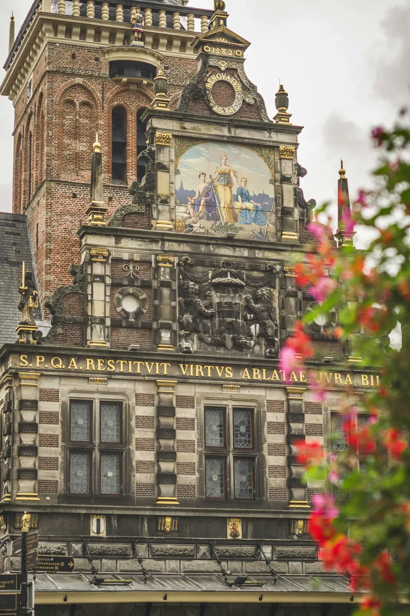 The carved coat of arms and gilded inscription on the Waag in Alkmaar