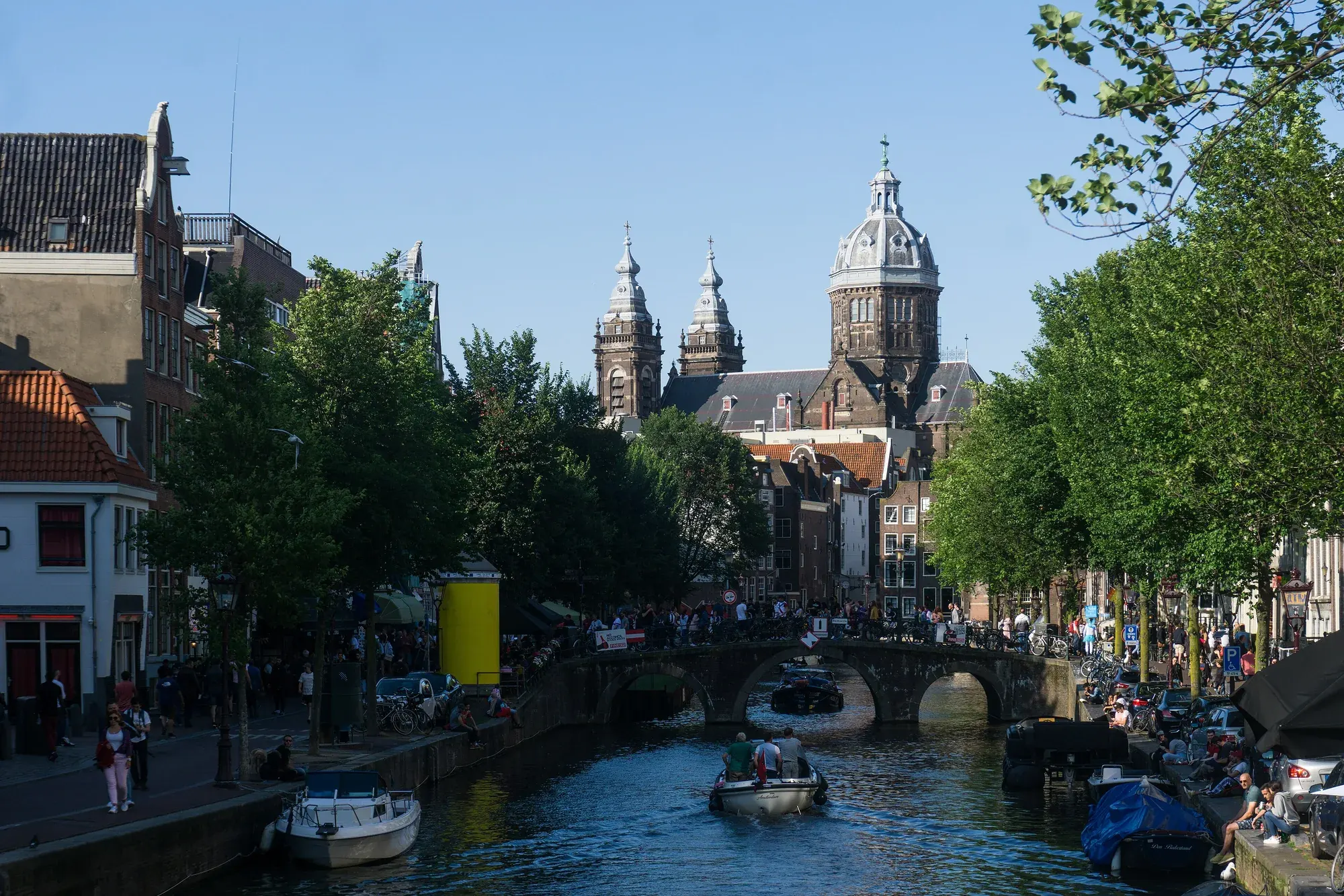 The domed towers of the Sint-Nicolaaskerk above a busy Amsterdam canal