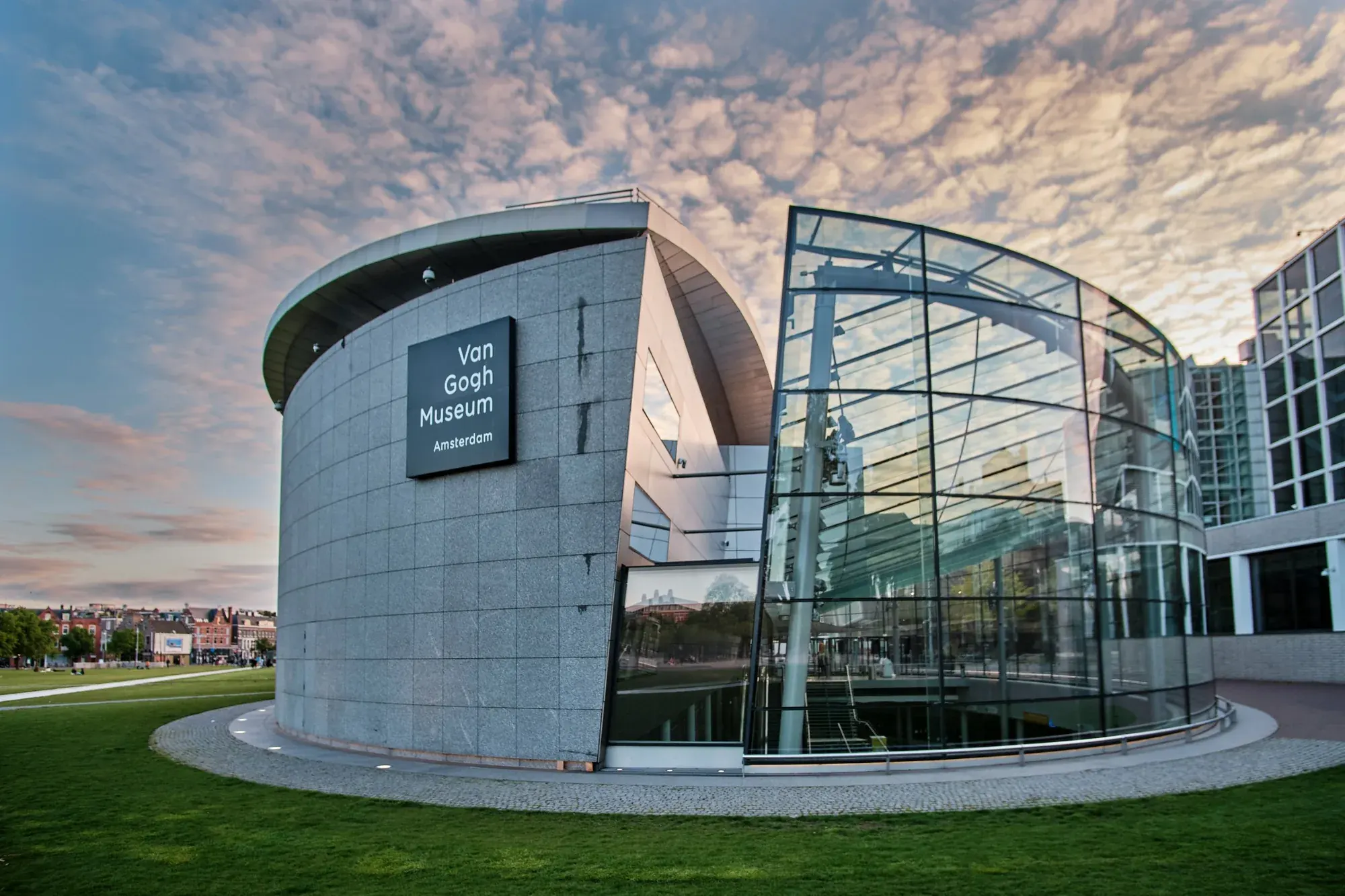 The Van Gogh Museum on the Museumplein in Amsterdam, with its round grey wing and glass entrance hall