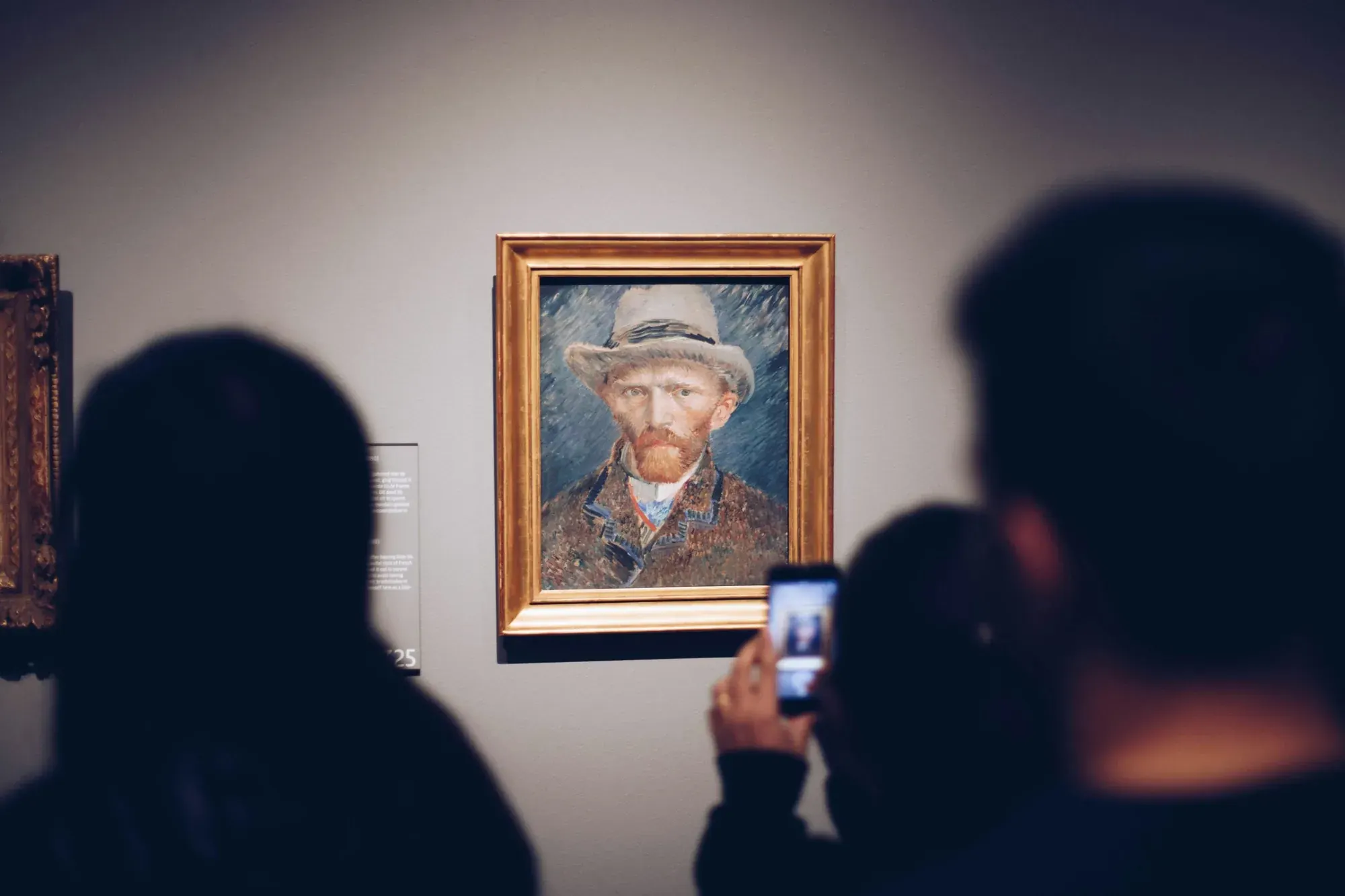 Visitors photographing Van Gogh's Self-Portrait with Grey Felt Hat in the Van Gogh Museum, Amsterdam