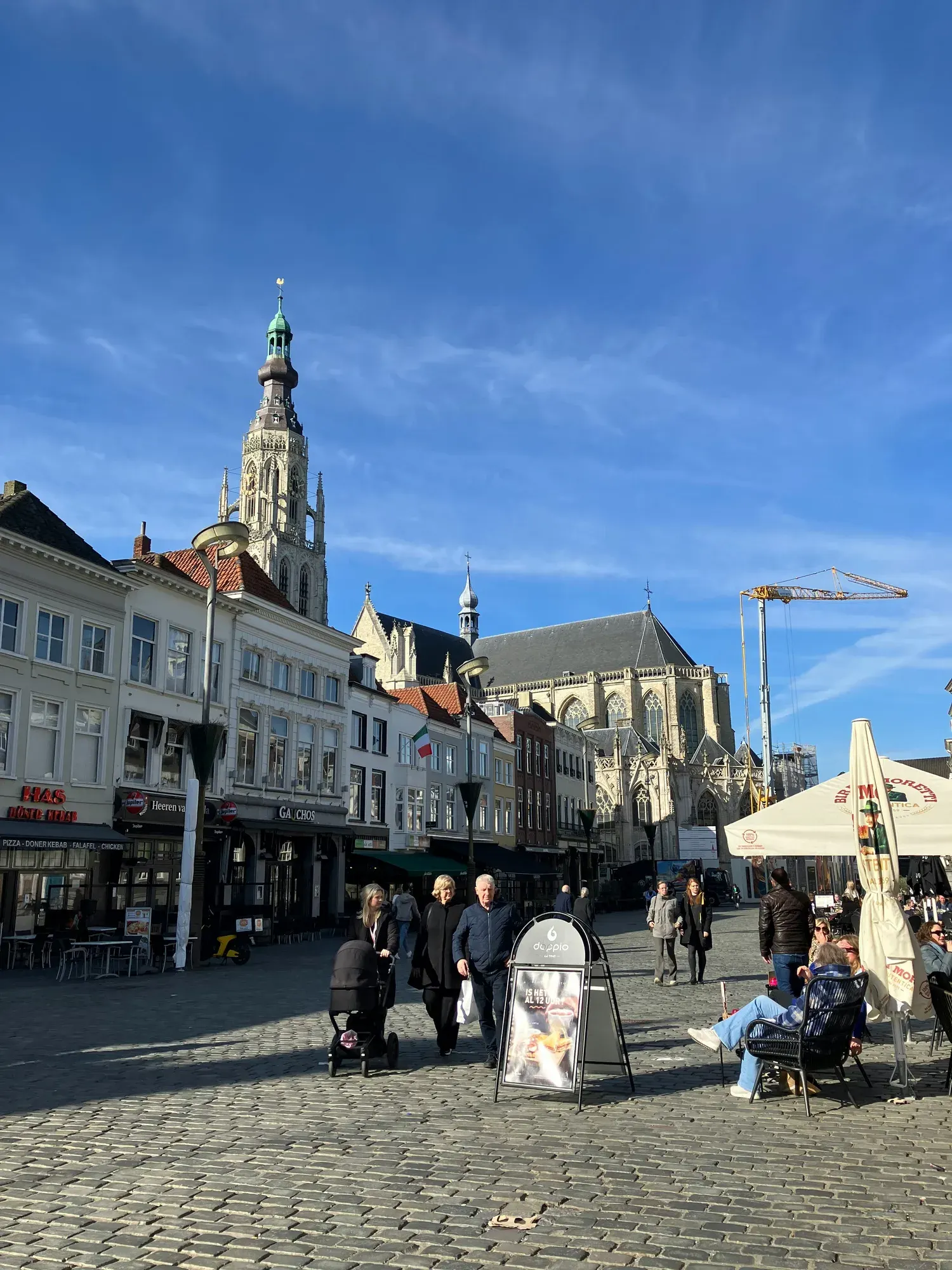 The Grote Markt in Breda with cafe terraces and the tower of the Grote Kerk behind