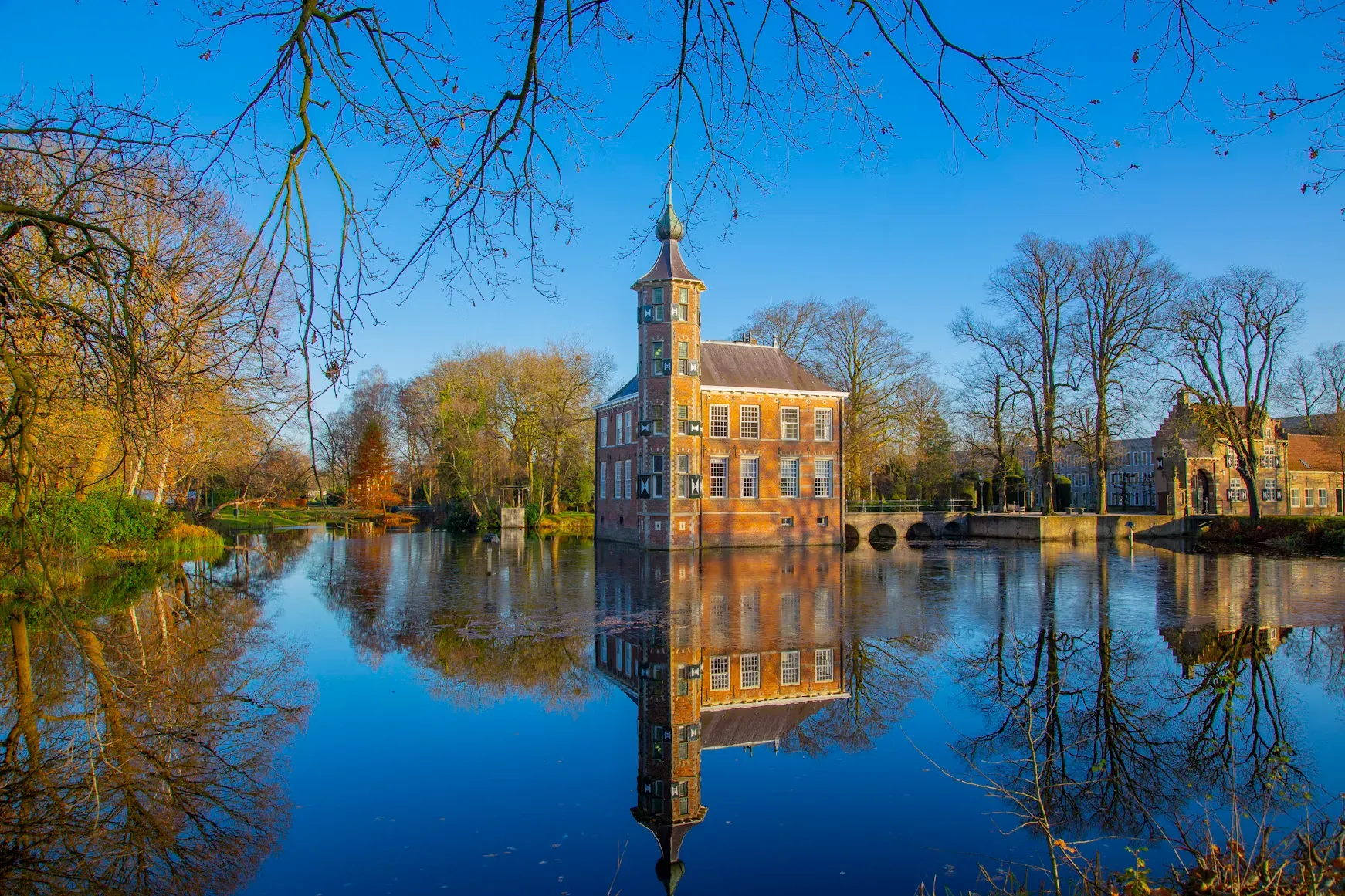 Kasteel Bouvigne mirrored in its moat on a bright winter morning, Breda