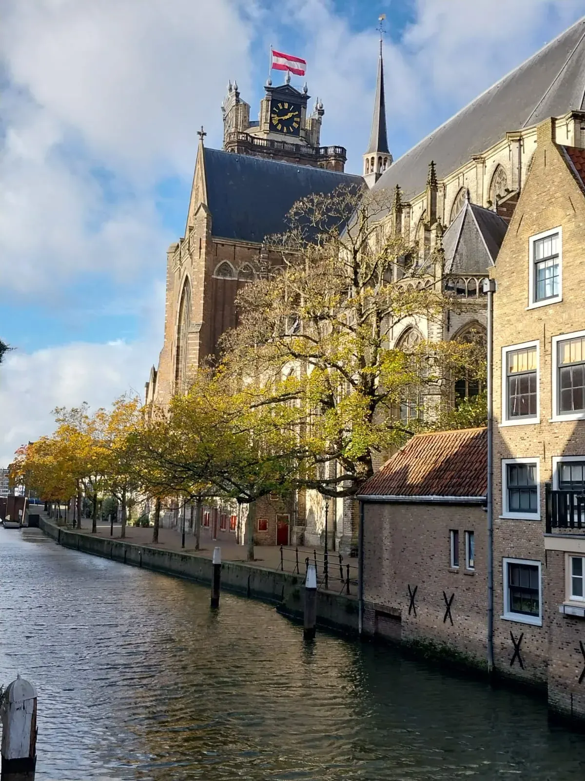 The tower of the Grote Kerk seen along the Nieuwe Haven canal in autumn, Dordrecht