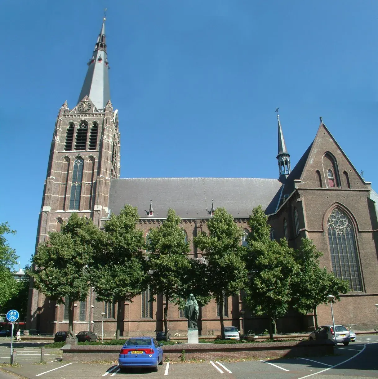 A tall brick church with a slender spire, Eindhoven