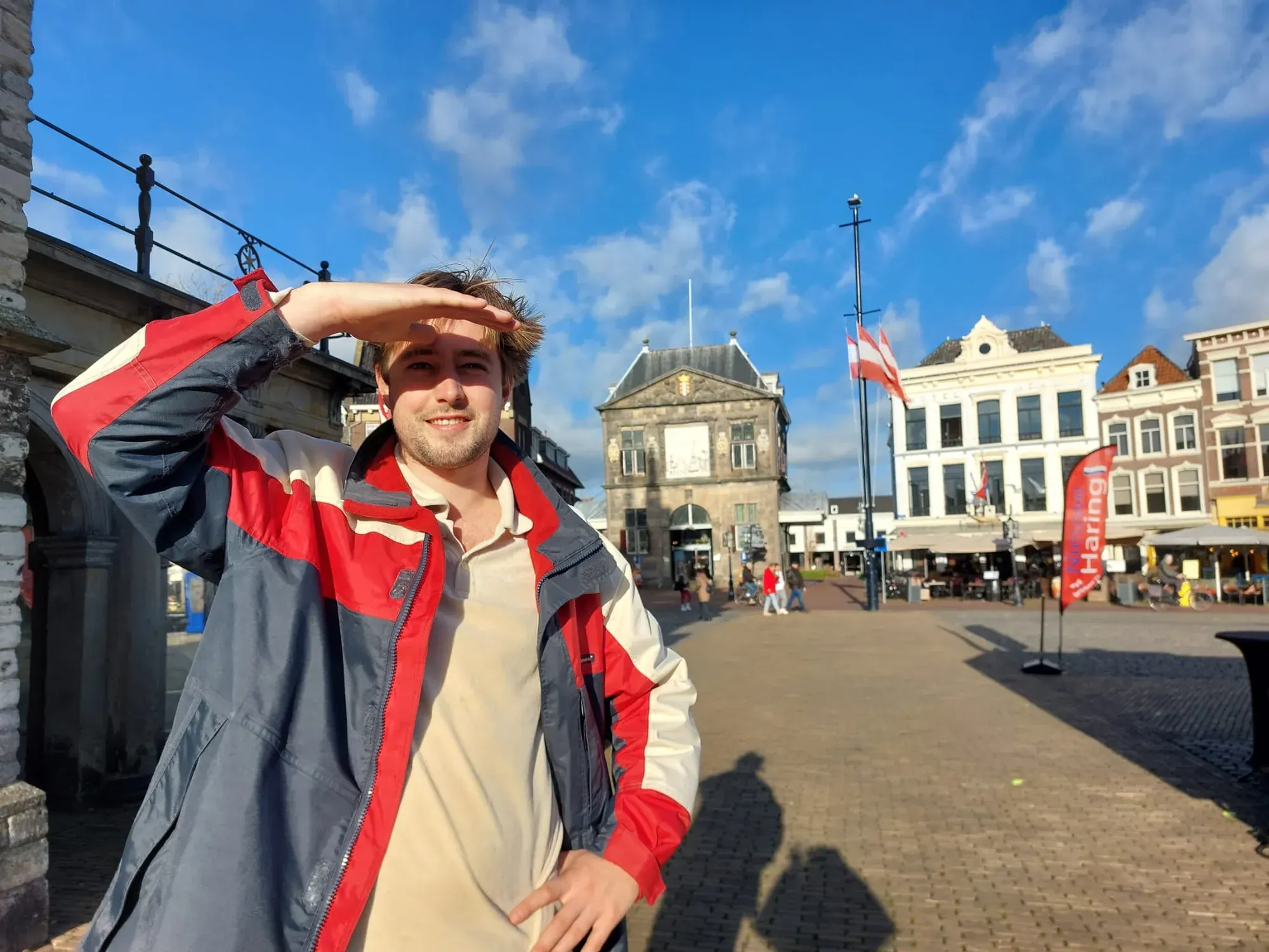 A guide on the Markt square with the Waag behind, Gouda