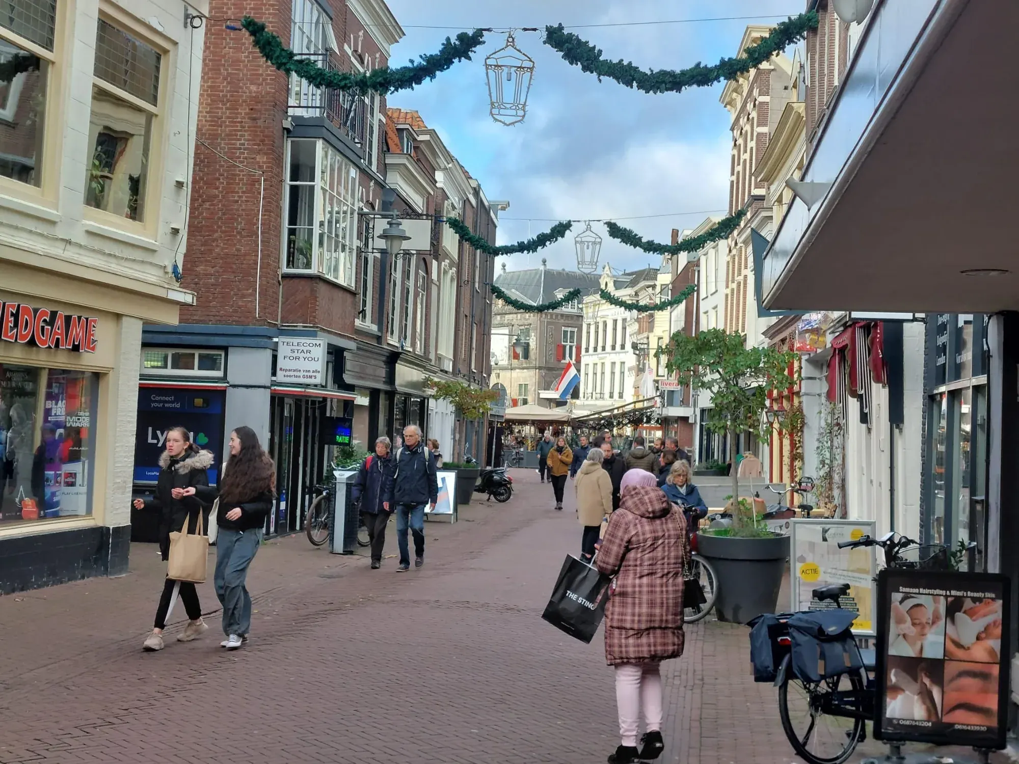 A pedestrian shopping street decorated for the holidays, Gouda
