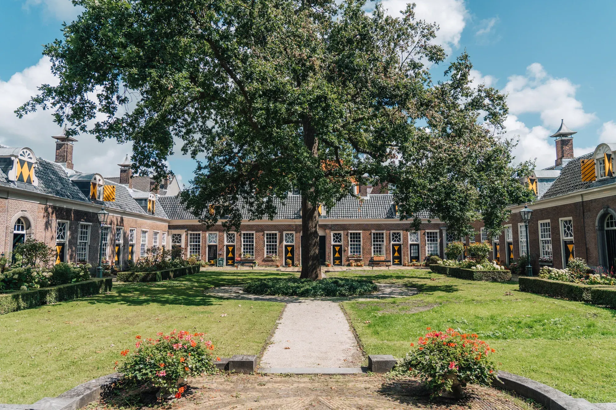 The lawn and rose beds of an almshouse courtyard, Haarlem