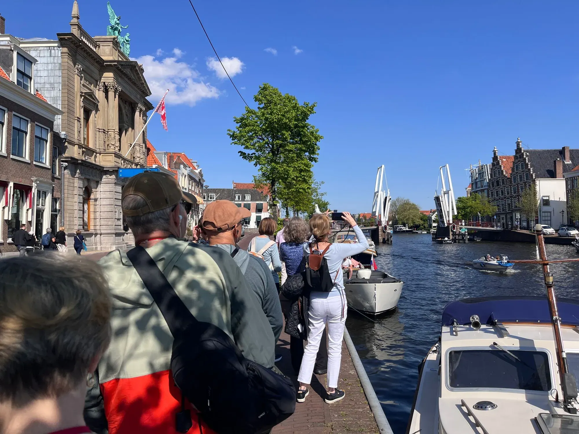 A tour group on the quay of the river Spaarne beside a drawbridge, Haarlem