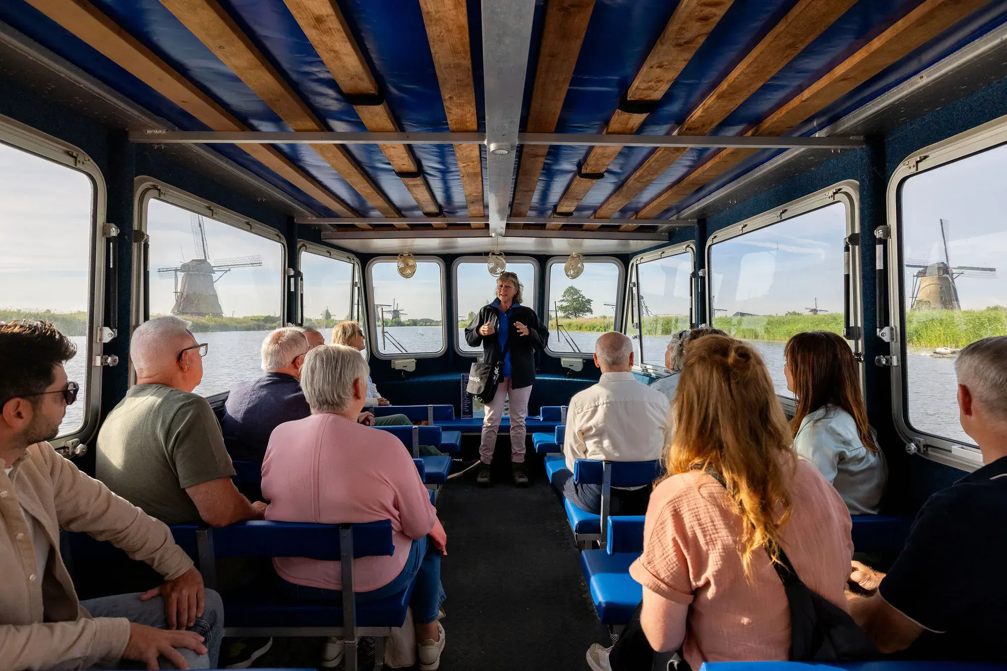 Inside the excursion boat at Kinderdijk with the guide
