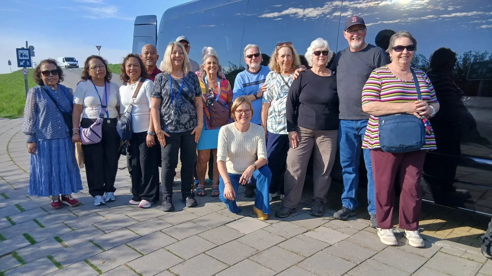 The shore excursion group together beside the tour minivan at Kinderdijk