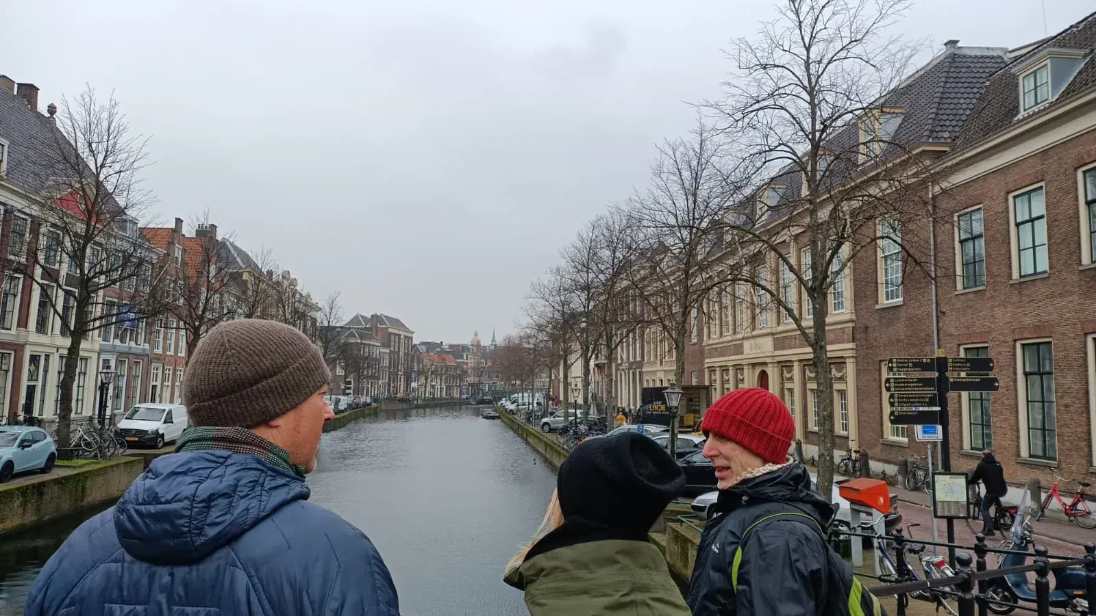 A guide and guests on a bridge over the Rapenburg canal in Leiden during a private two-city walking tour