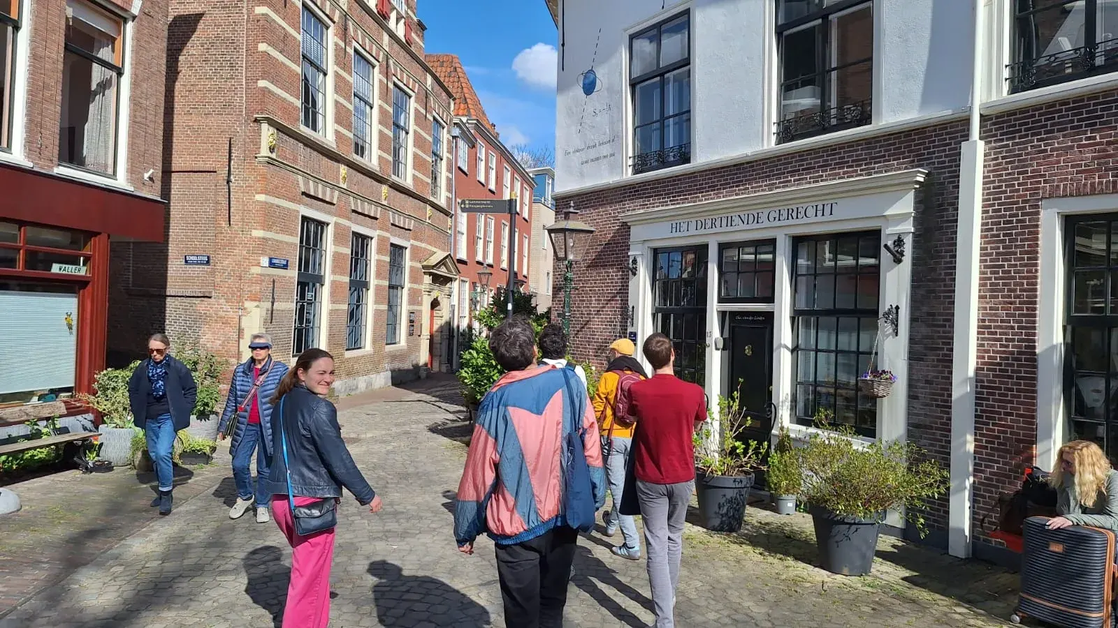 A tour group in front of the Pieterskerk in Leiden under cherry blossom in spring