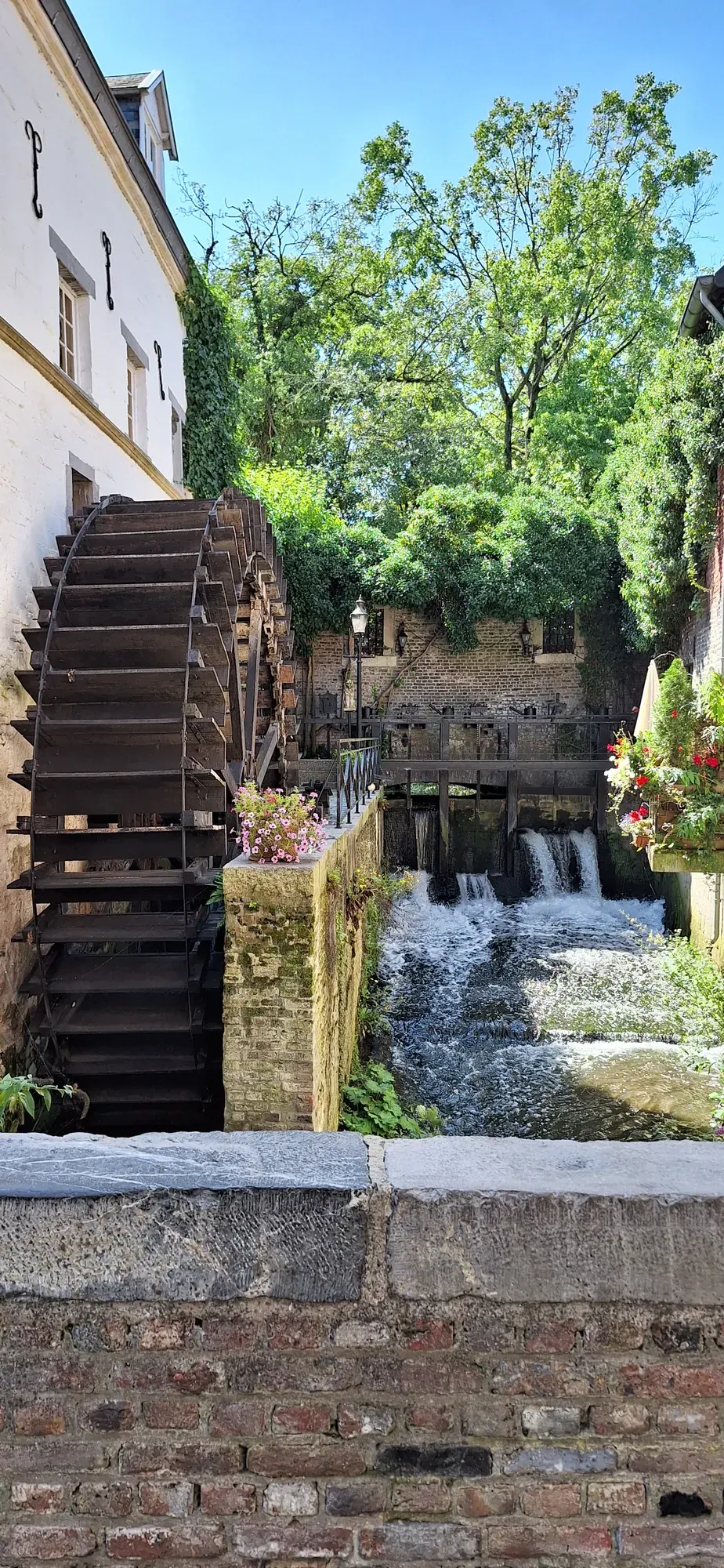 A wooden water wheel and its waterfall on the river Jeker, Maastricht