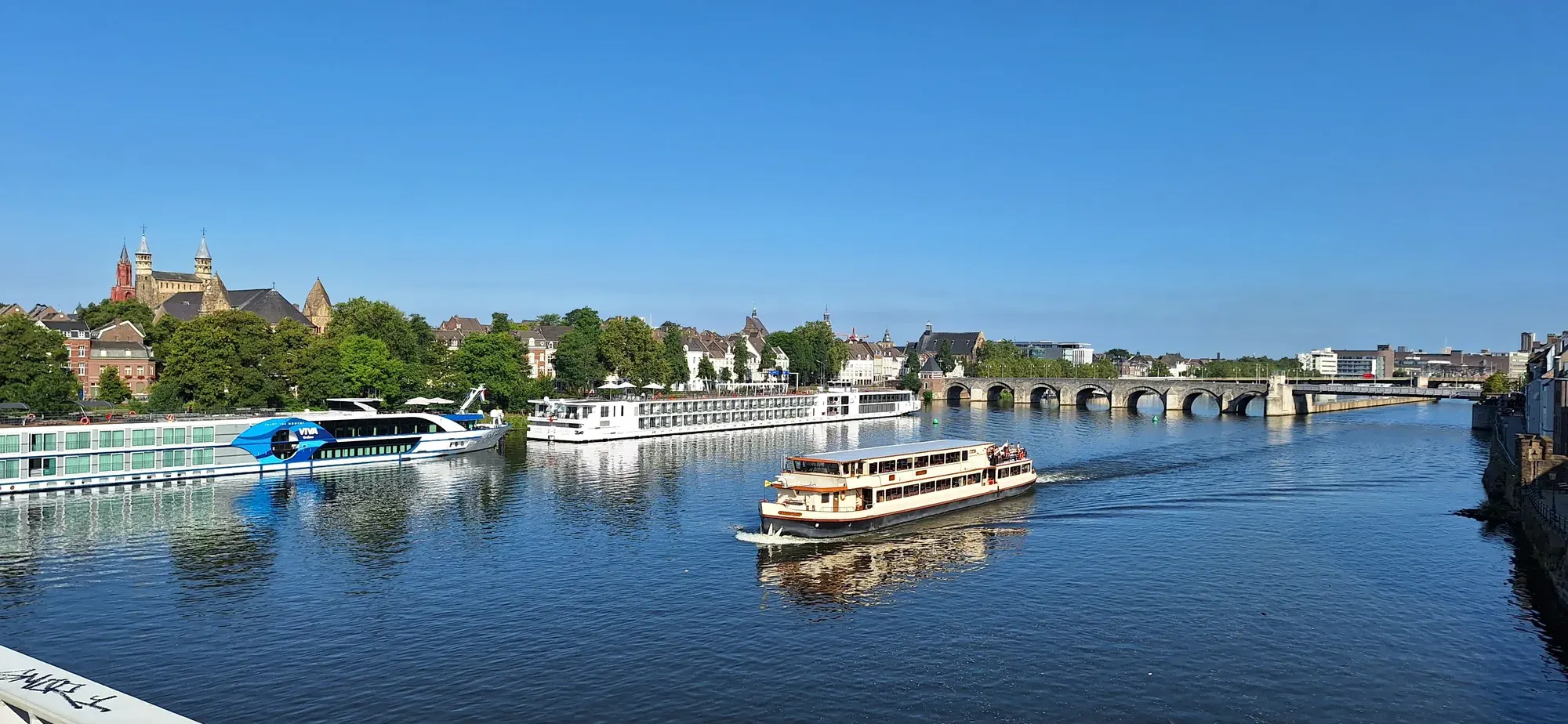 River cruise ships moored on the Maas near the Sint-Servaasbrug, Maastricht