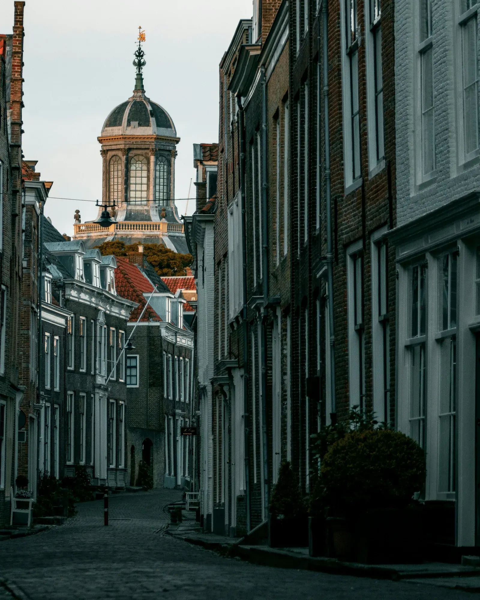 The Oostkerk dome seen down a narrow street at dusk in Middelburg