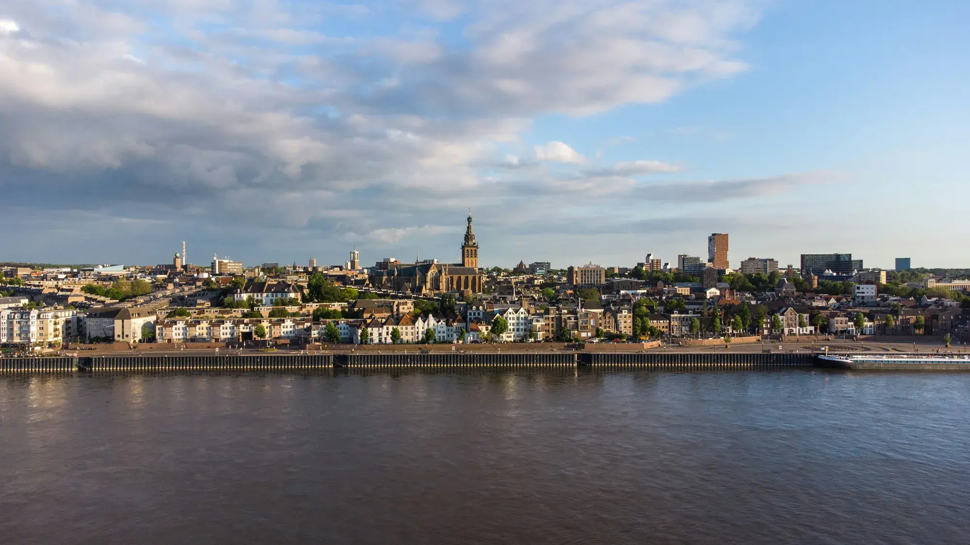 Nijmegen seen across the Waal, with the Stevenskerk tower above the Waalkade quay