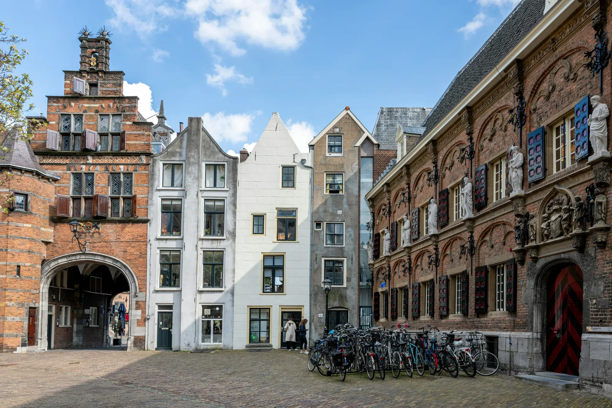The Stevenskerkhof in Nijmegen, with the Kerkboog arch and an ornate statued facade