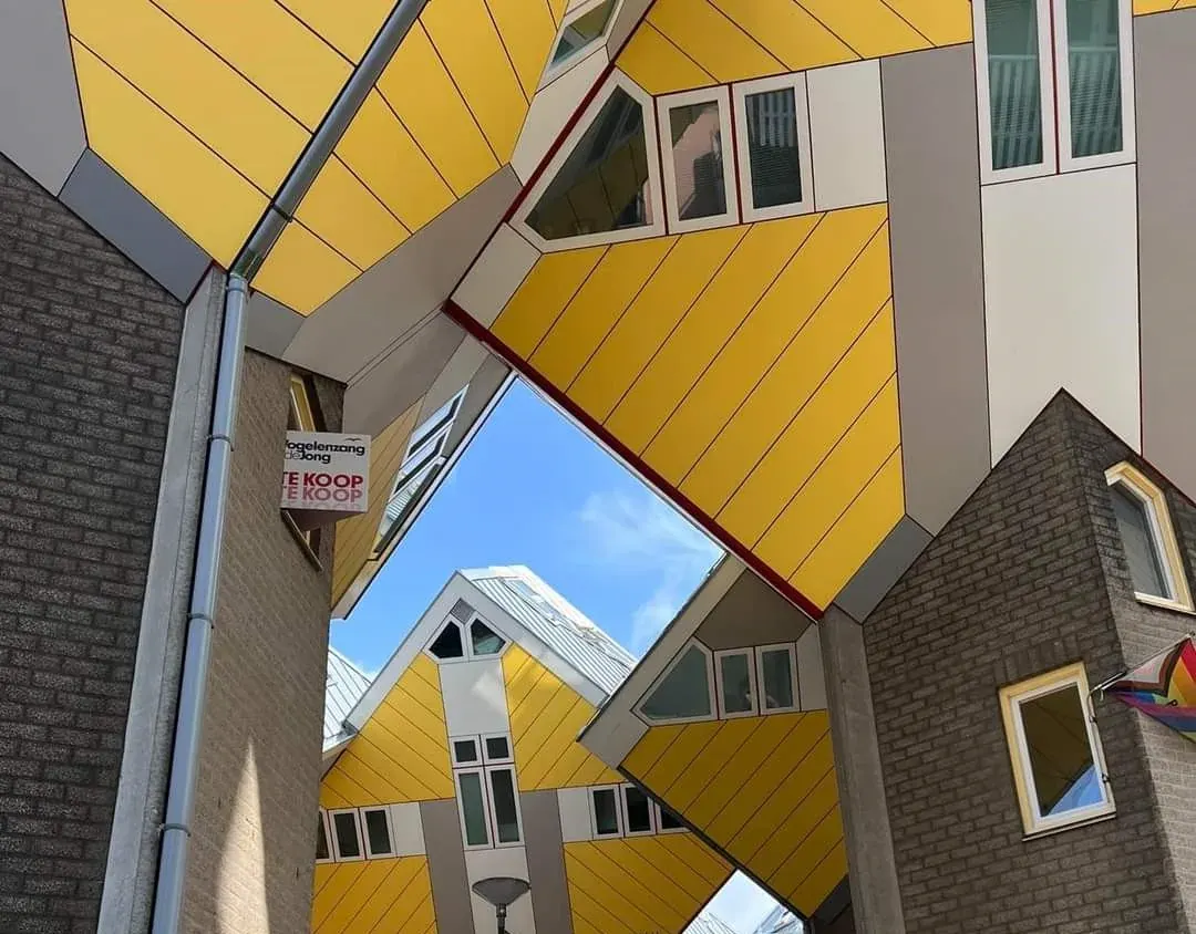 Looking up between the tilted yellow Cube Houses, Rotterdam