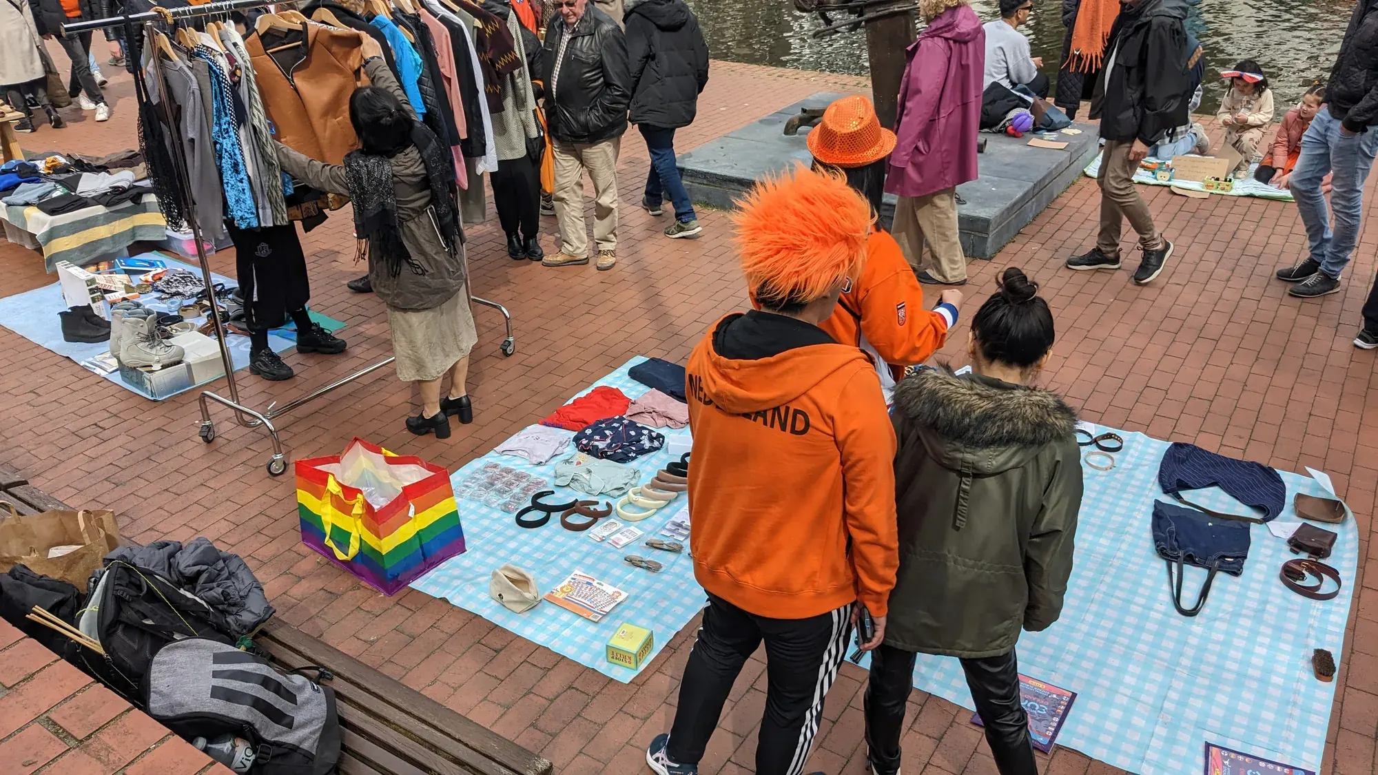 People in orange browsing a King's Day free market in Rotterdam