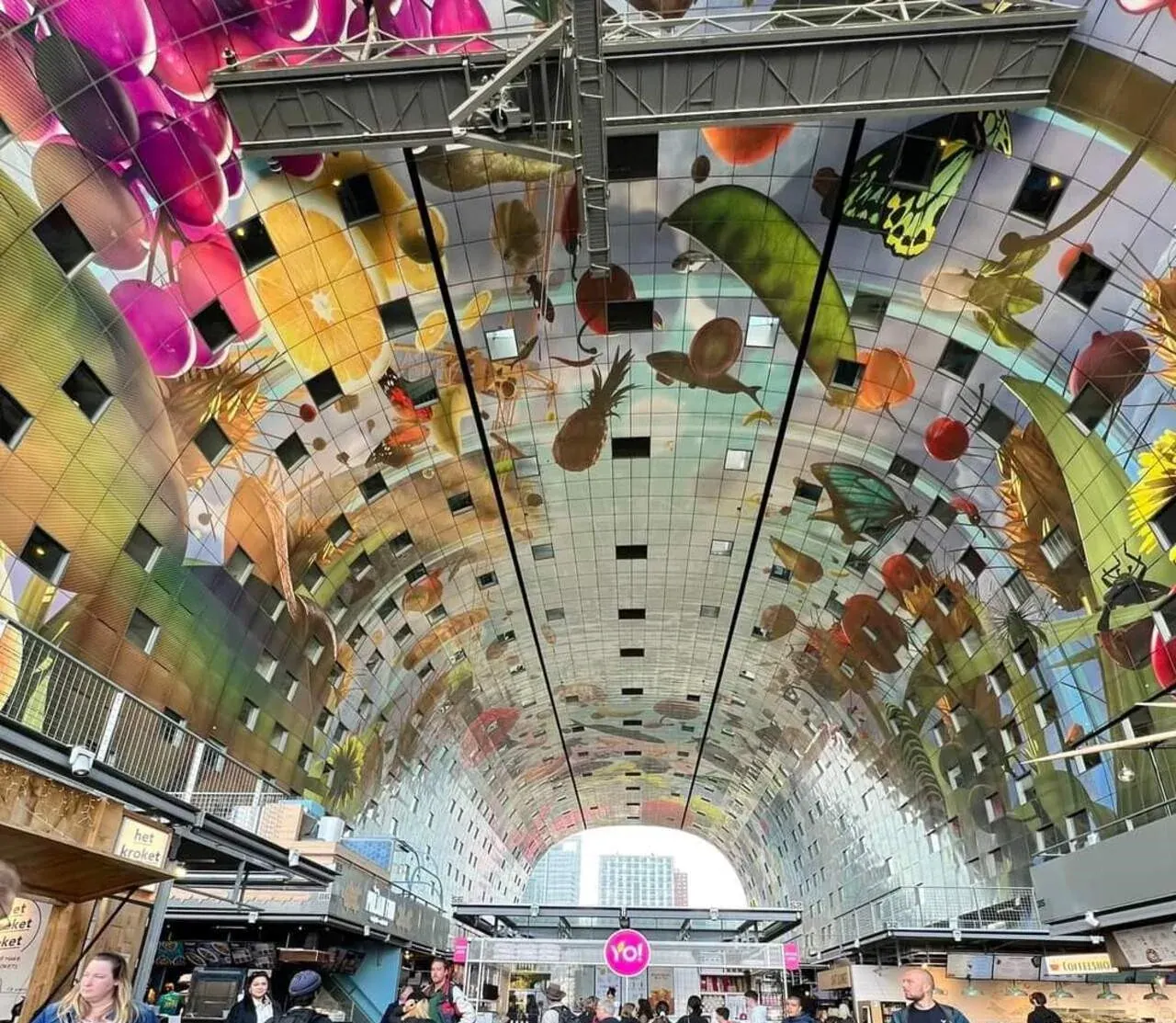 The painted ceiling of the Markthal in Rotterdam seen across the hall