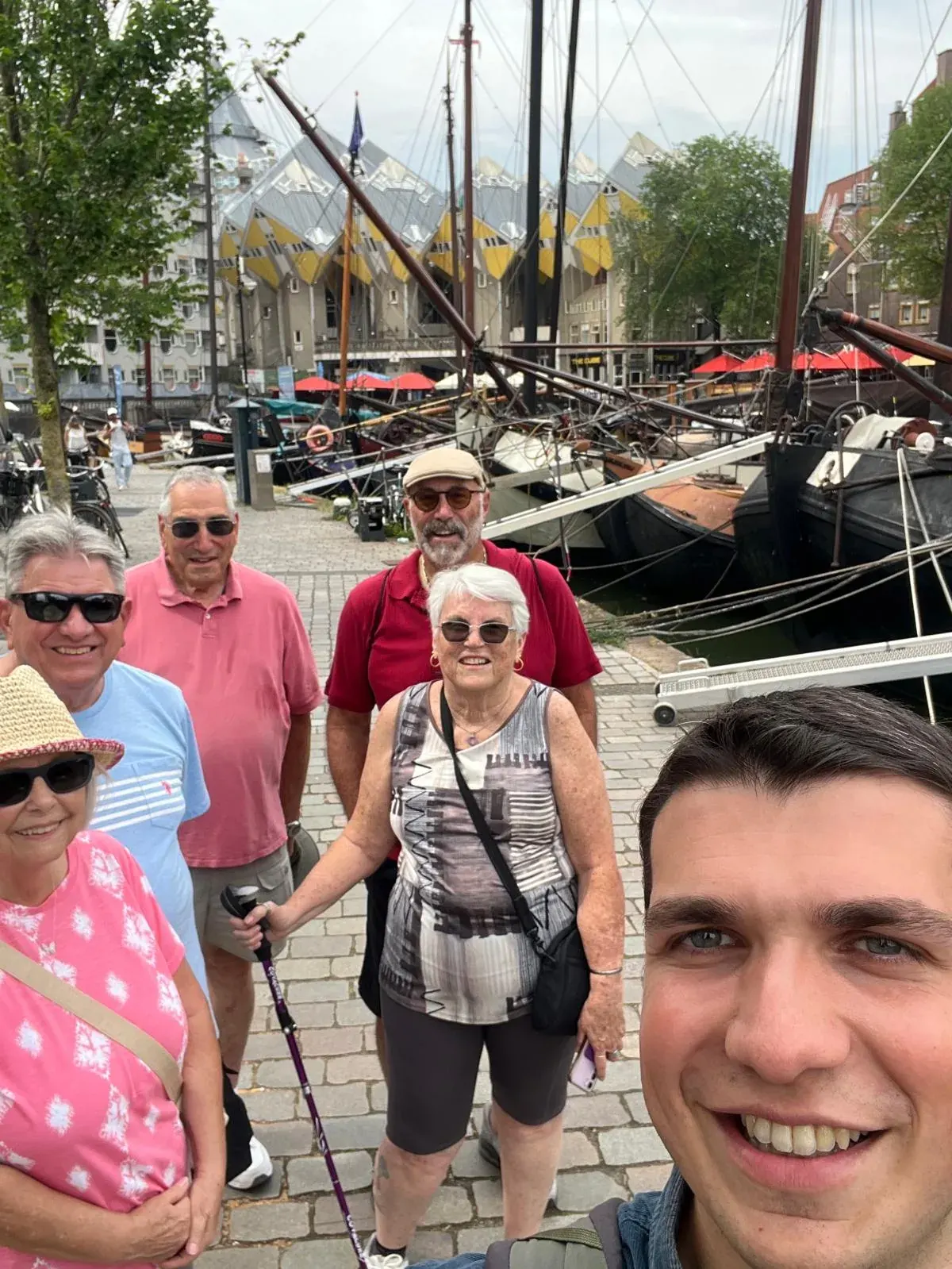 A guide taking a selfie with four smiling guests at the Oude Haven, Cube Houses behind, Rotterdam