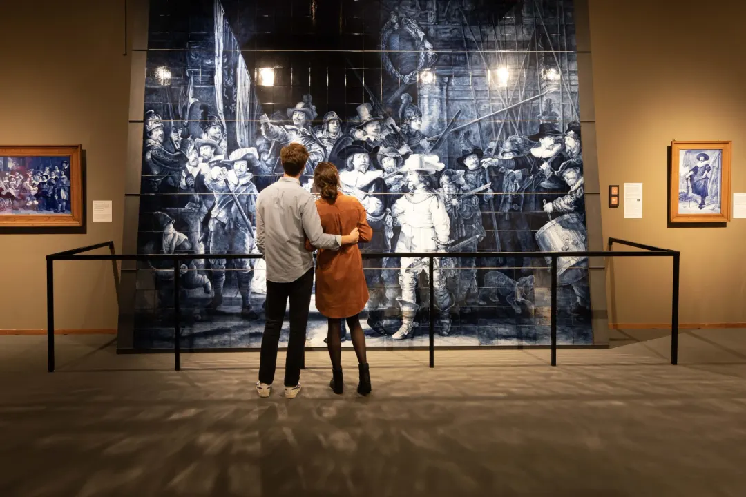 Visitors at the Delft Blue tile reproduction of Rembrandt's Night Watch at Royal Delft