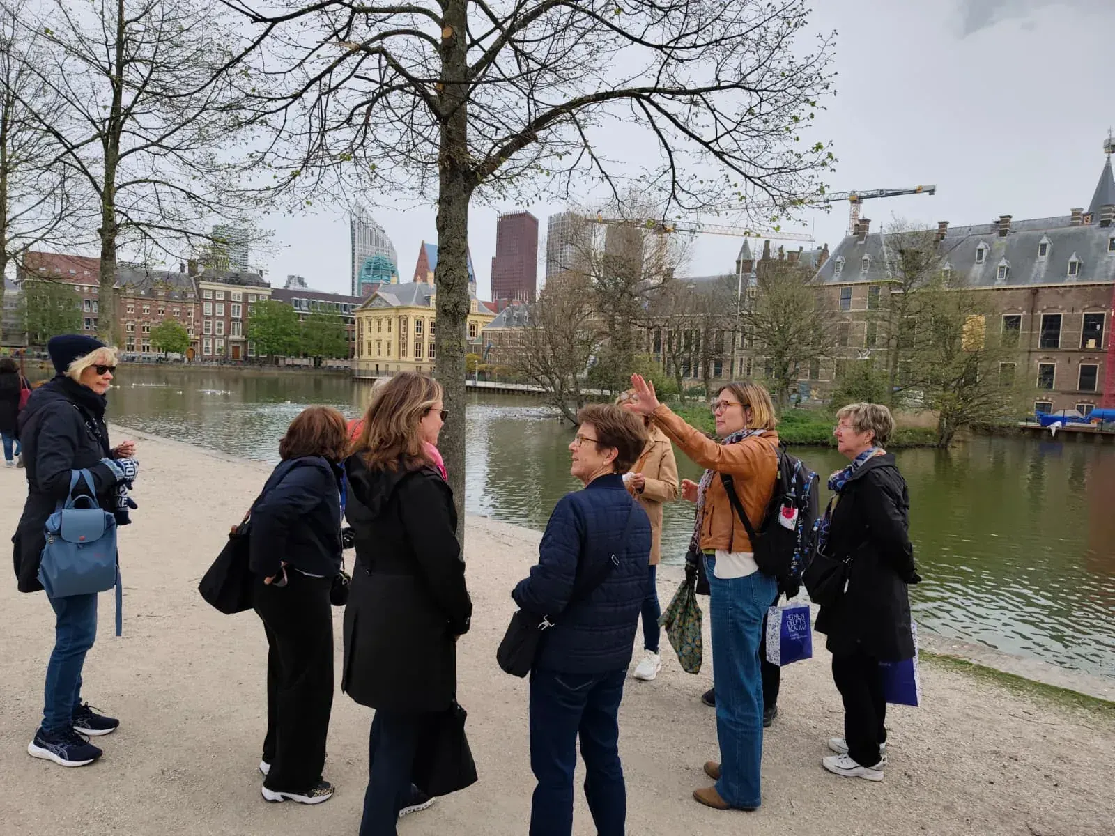 A guide and a small group beside the Hofvijver, The Hague