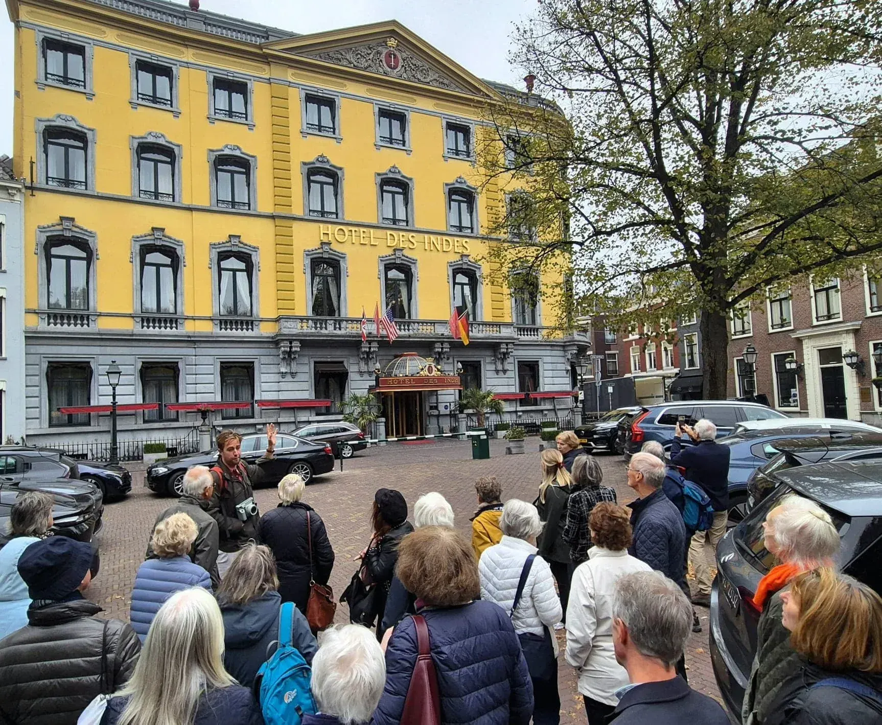 A guide and group in front of Hotel Des Indes, The Hague
