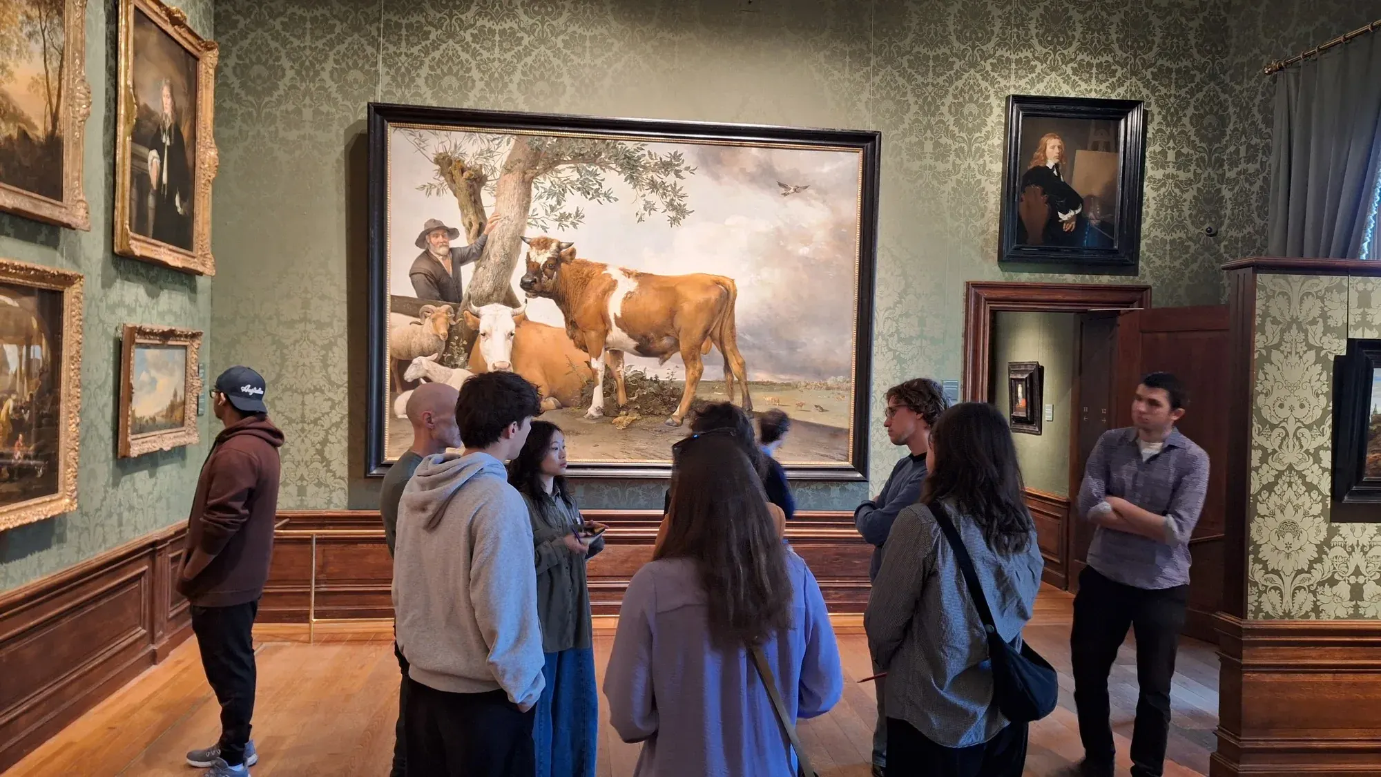 Guests on a private museum tour in front of Paulus Potter's life-size The Bull