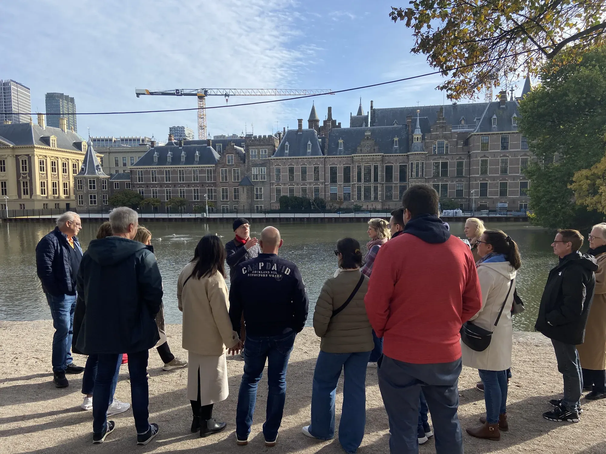 A tour group at the Hofvijver looking across the water to the Binnenhof, The Hague