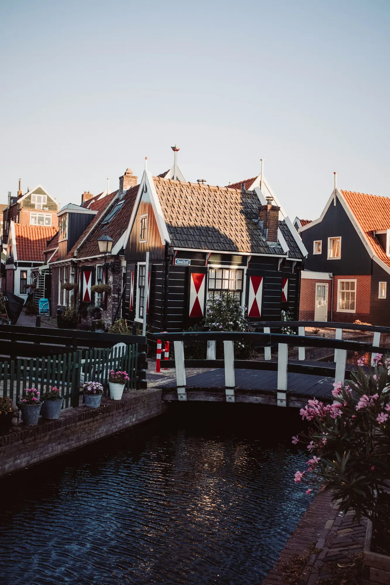 Timber houses and a footbridge in the Doolhof quarter of Volendam at dusk