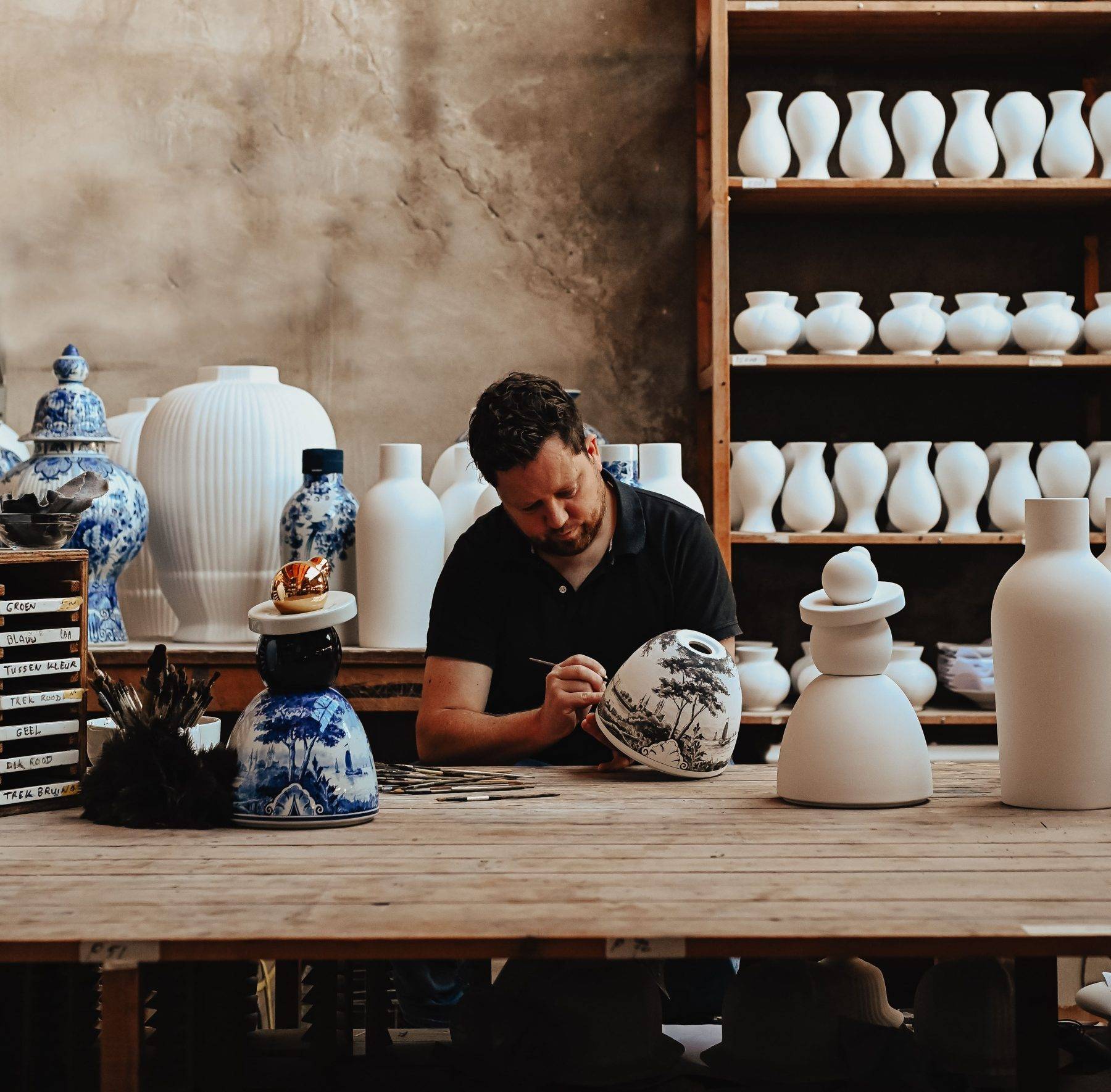 Painter painting ceramics at Royal Delft